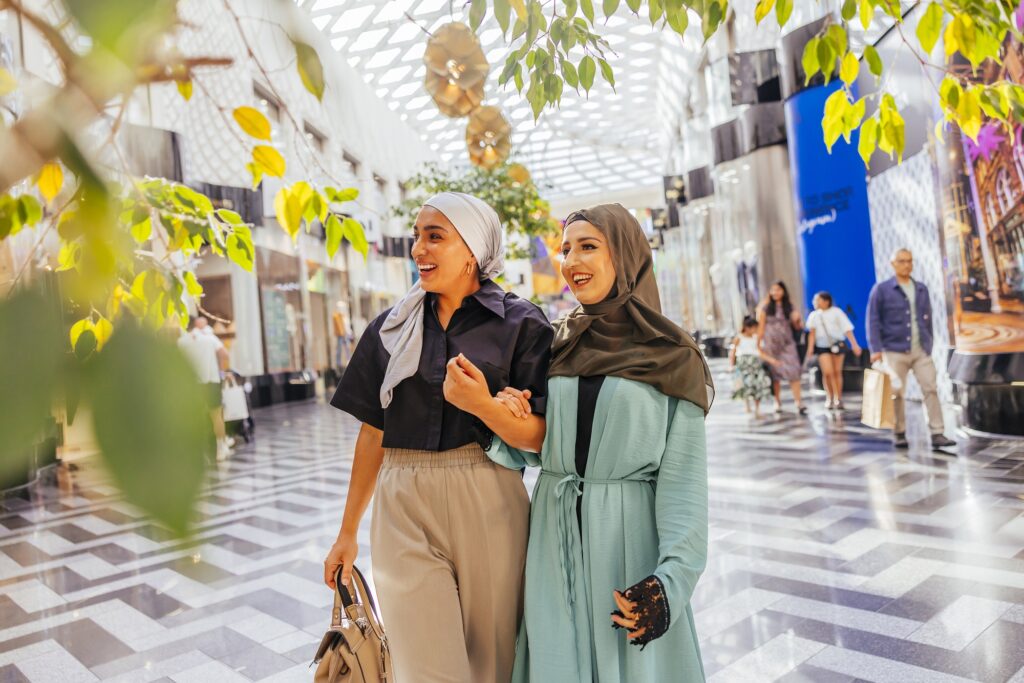Two women shopping in a sunny Victoria Gate arcade