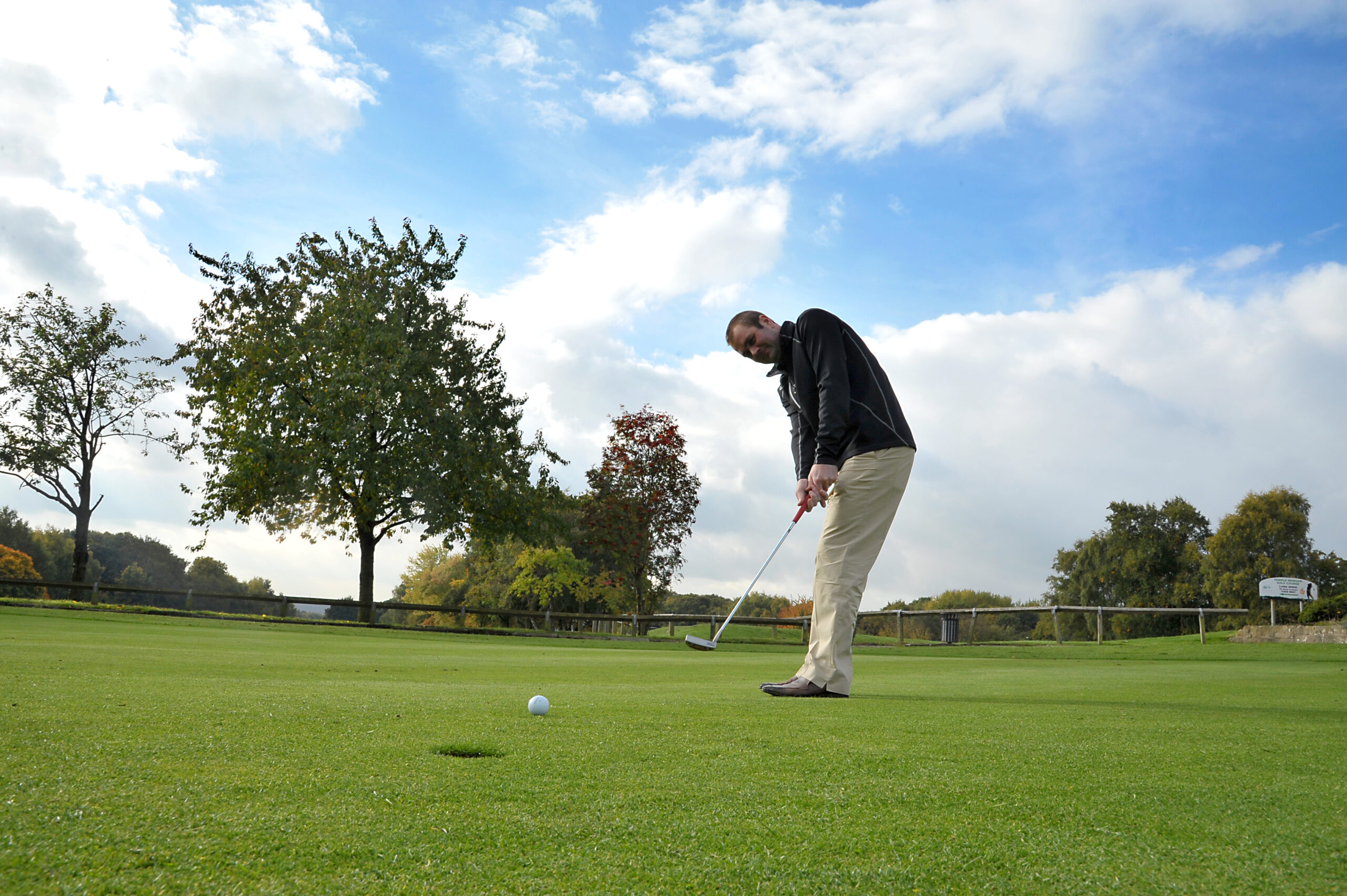 A man playing golf on a sunny day at Temple Newsam Golf Club