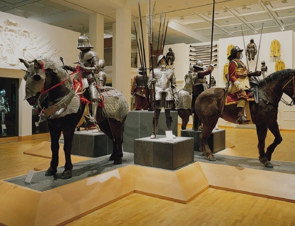 Picture of statues of knights and horses in armour holding sword inside the Royal armouries