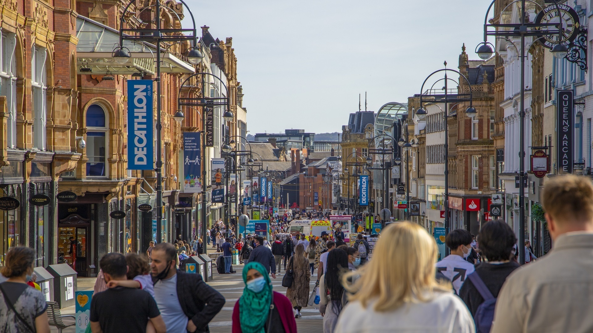street lined with shops and people walking through