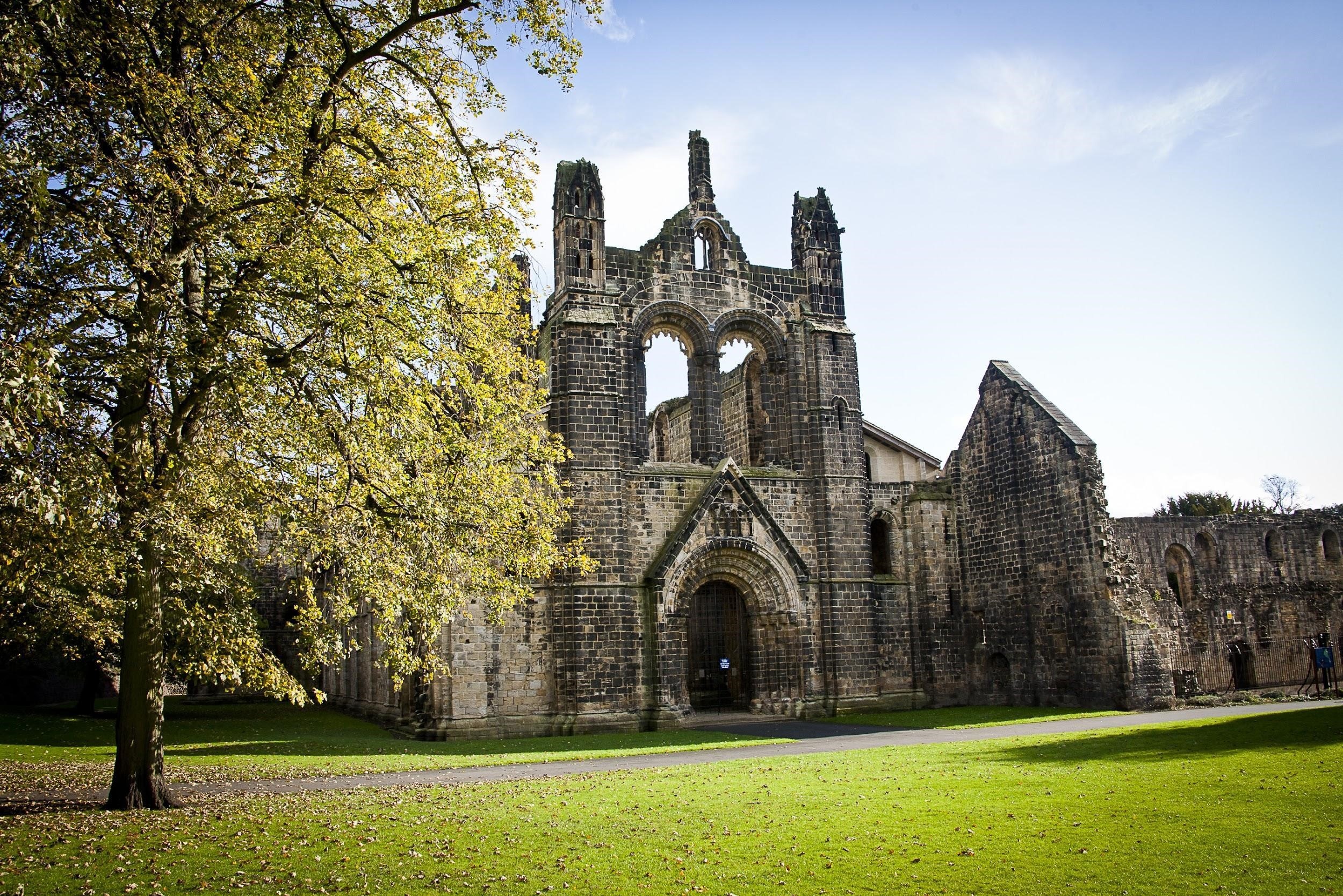 Kirkstall Abbey on a sunny day with lovely trees surrounding