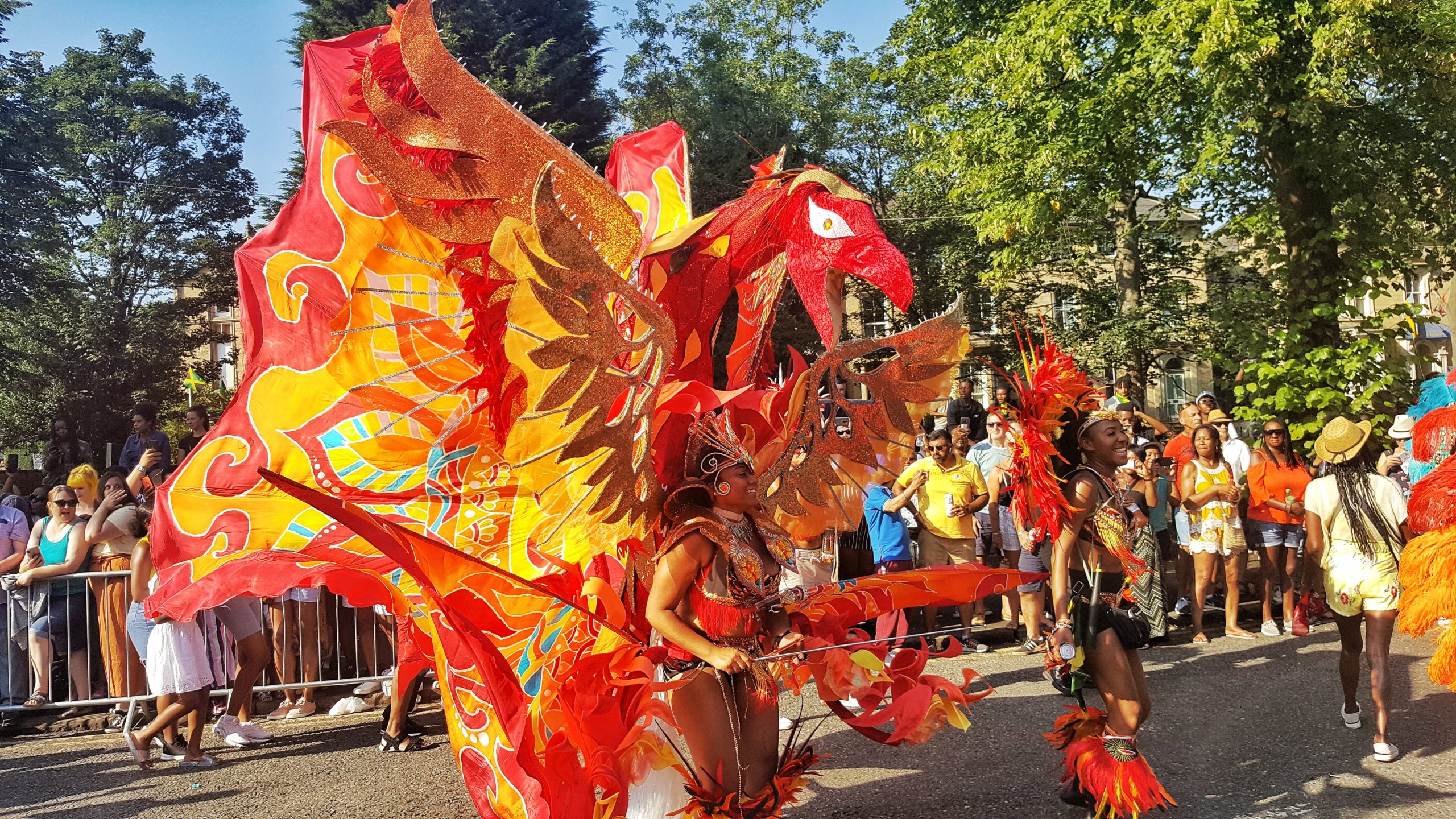 Picture taken during Leeds West-Indian Carnival of someone wearing a costume of colourful dragon