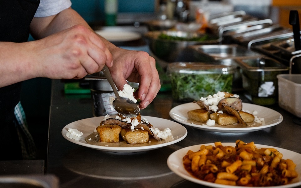 A chef plating up meals at Sarto restaurant