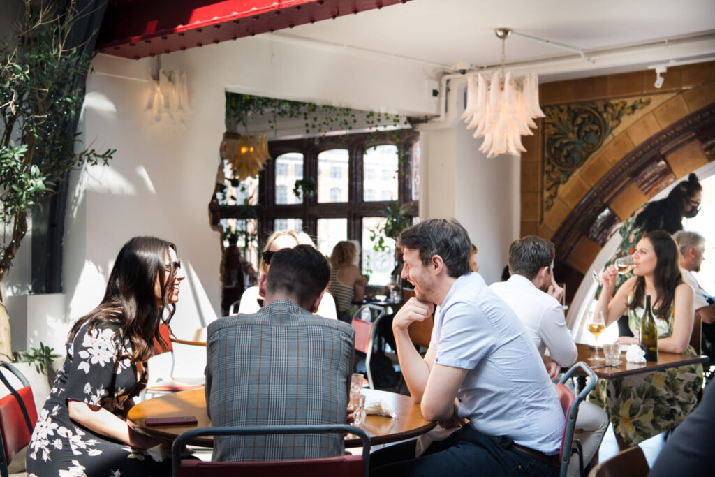 A group of people sitting around a table at Stuzzi restaurant