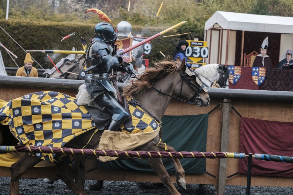 Knights re-enact a medieval jousting on horseback