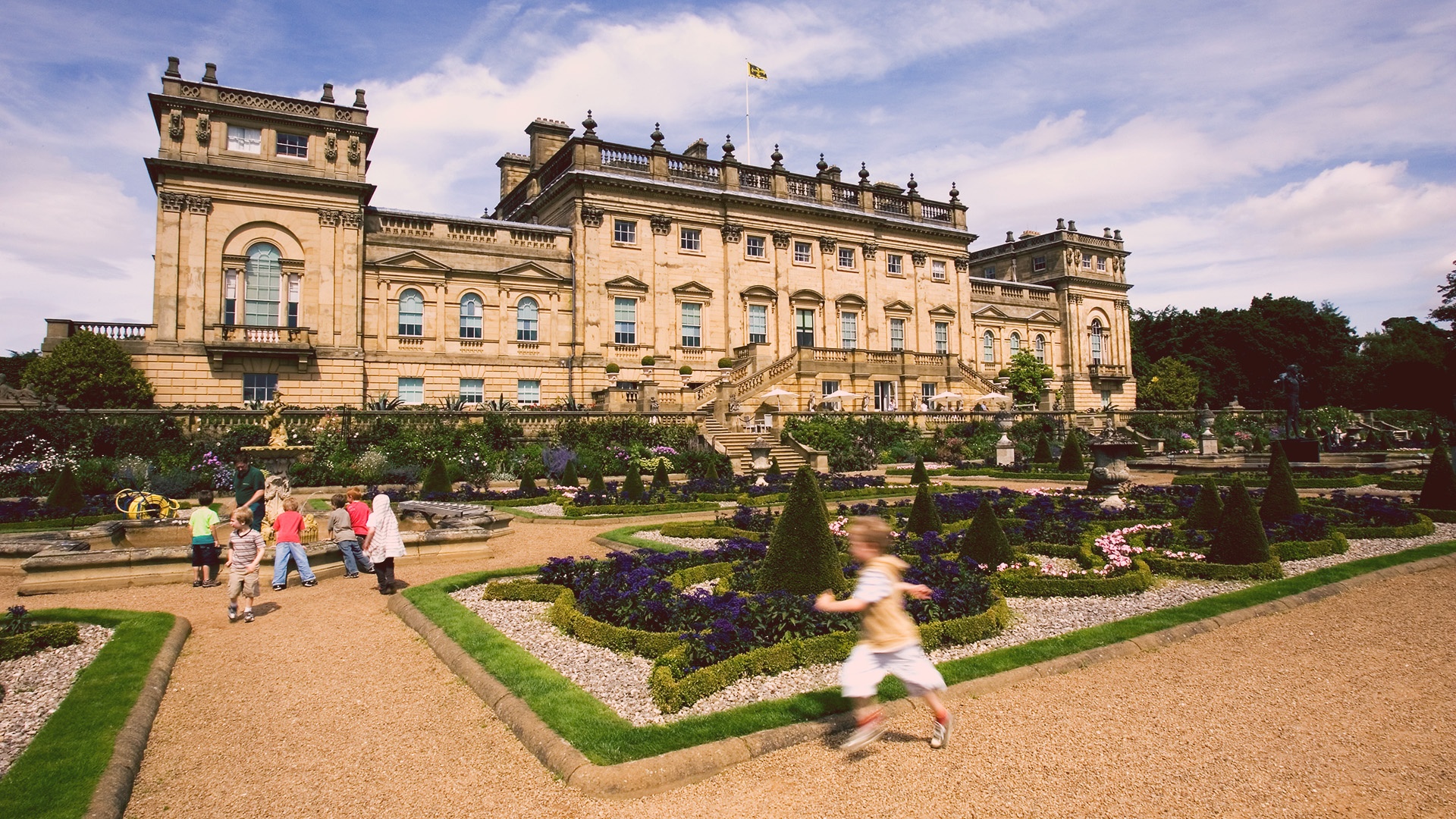 Child plays in grounds of Harewood with House in background