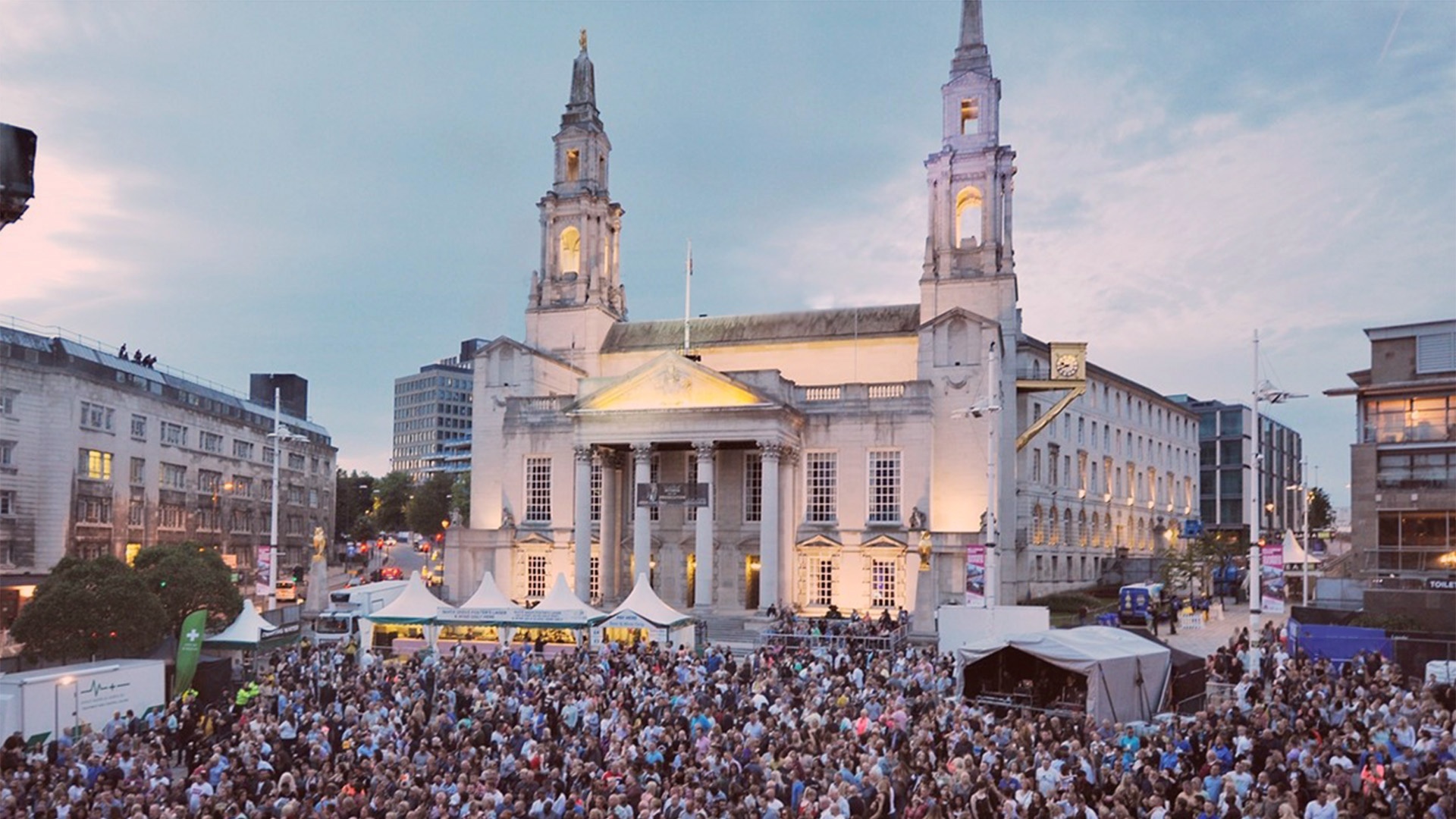 Crowd at Millennium Square seen from the main stage with Leeds Civic Hall in the background.