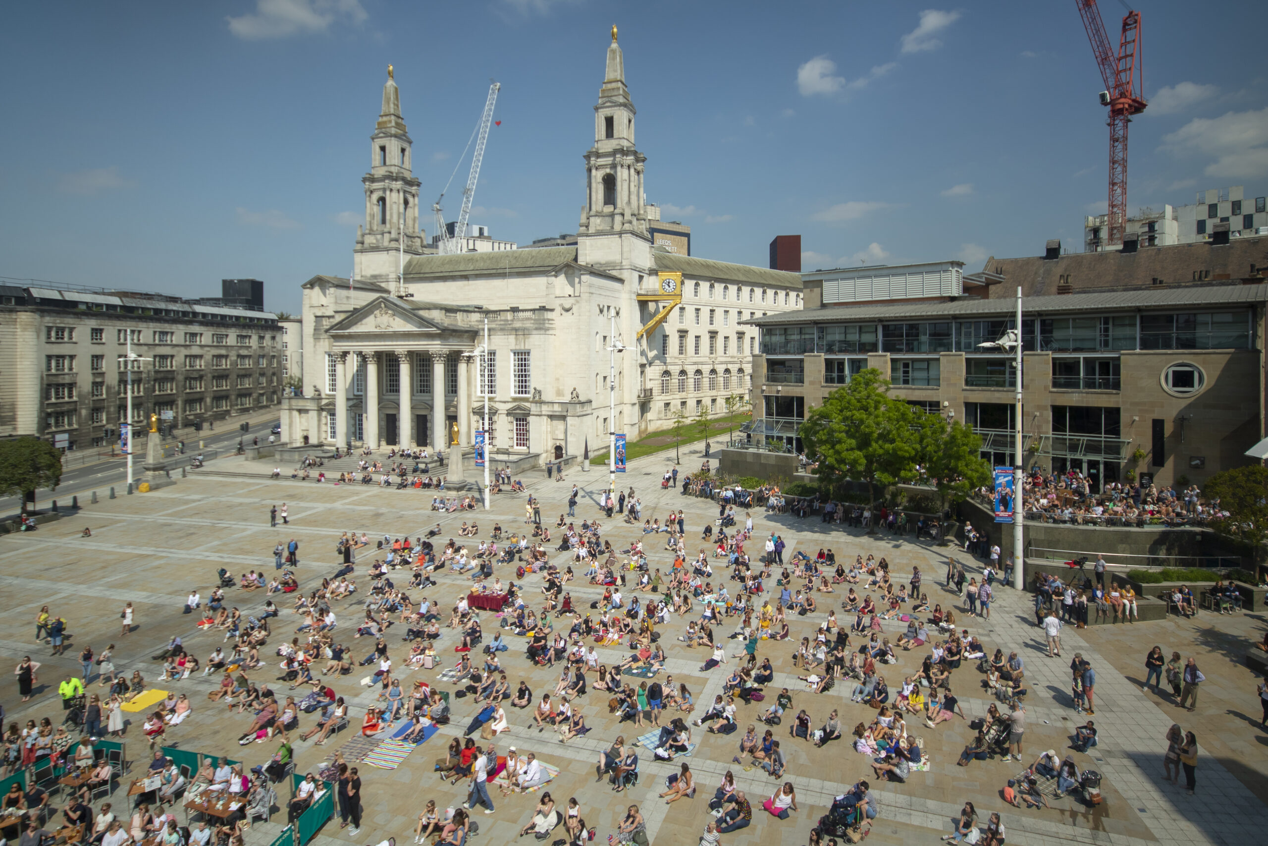 People sitting on blankets in Millennium Square seen from above