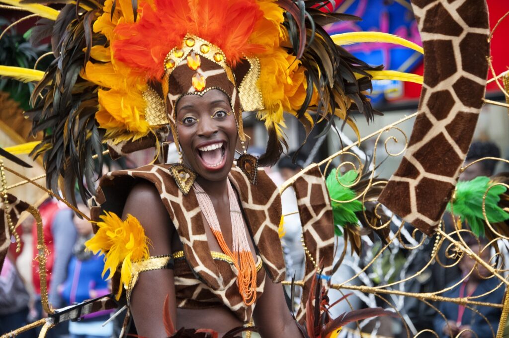 Carnival performer smiles for camera in Giraffe outfit