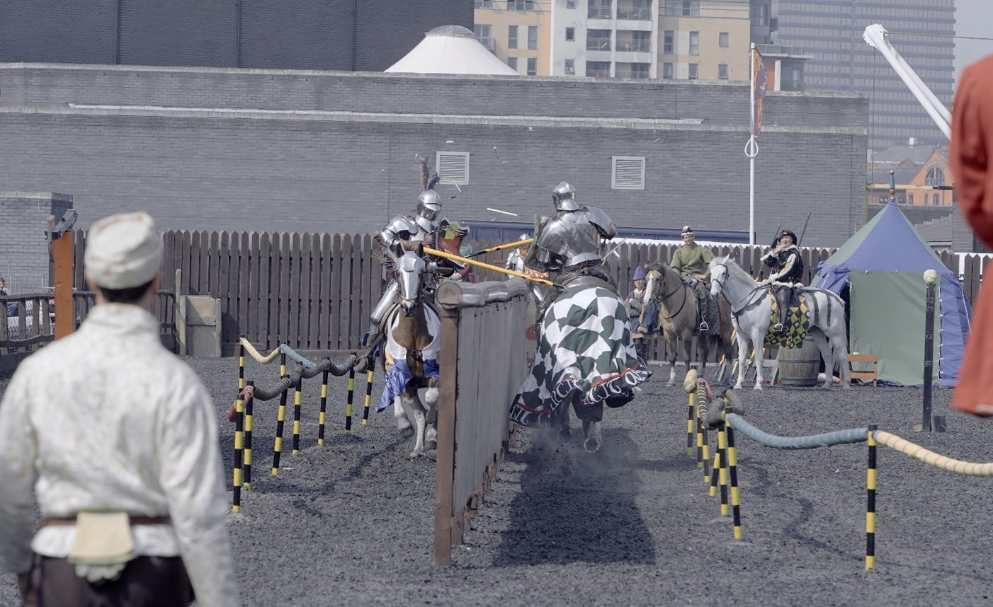 Picture of people dressed as medieval knights and jousting
