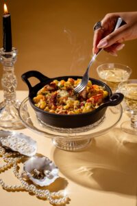 a bowl lobster mac cheese decorated with jewels