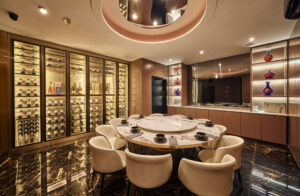 a private dining room showing a table set up for dinner and wine racks lining the walls