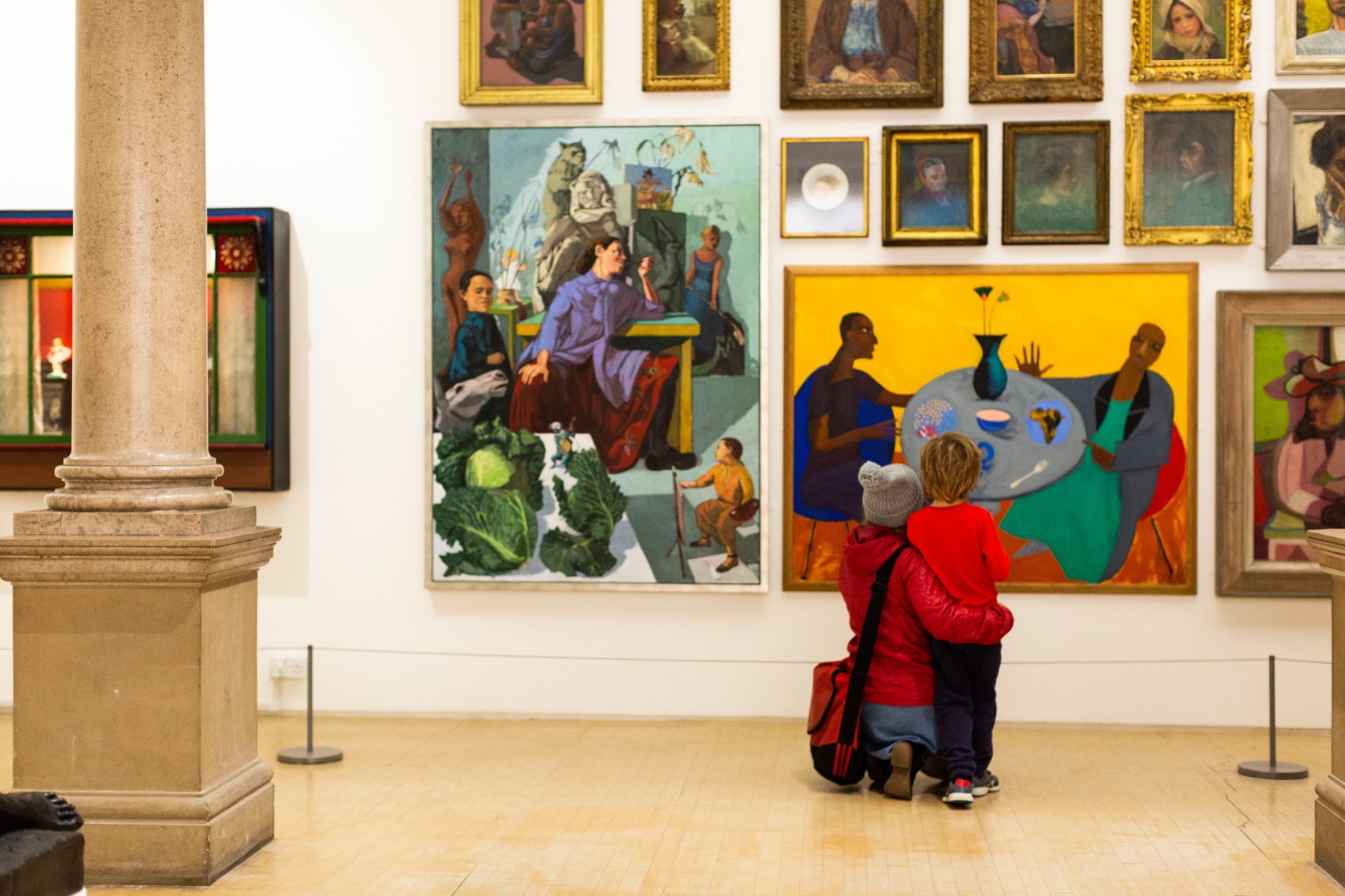 A woman and child looking at portraits on the wall at Leeds Art Gallery