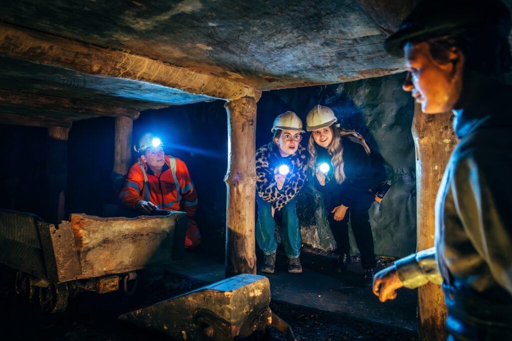 A family exploring underground at the National Coal Mining Museum