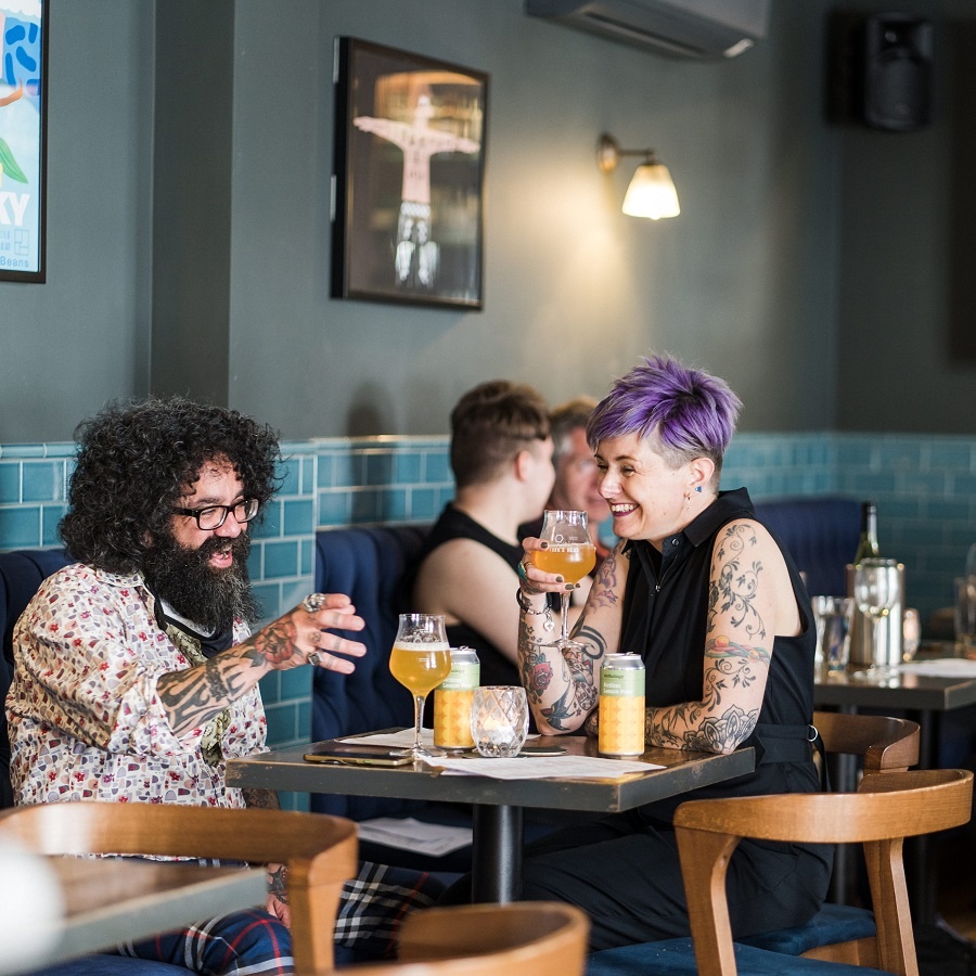 Picture of a man and a women having a drink in Whitelocks Bar
