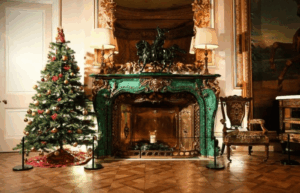 an old green fireplace with a christmas tree next to it