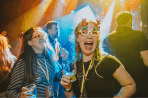 people partying wearing silly glasses under flashinglights