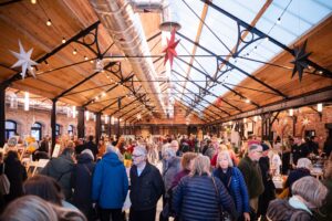 a crowd of people walking through a building