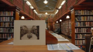 a photograph of how the leeds library looked years ago sat on a desk in the same room