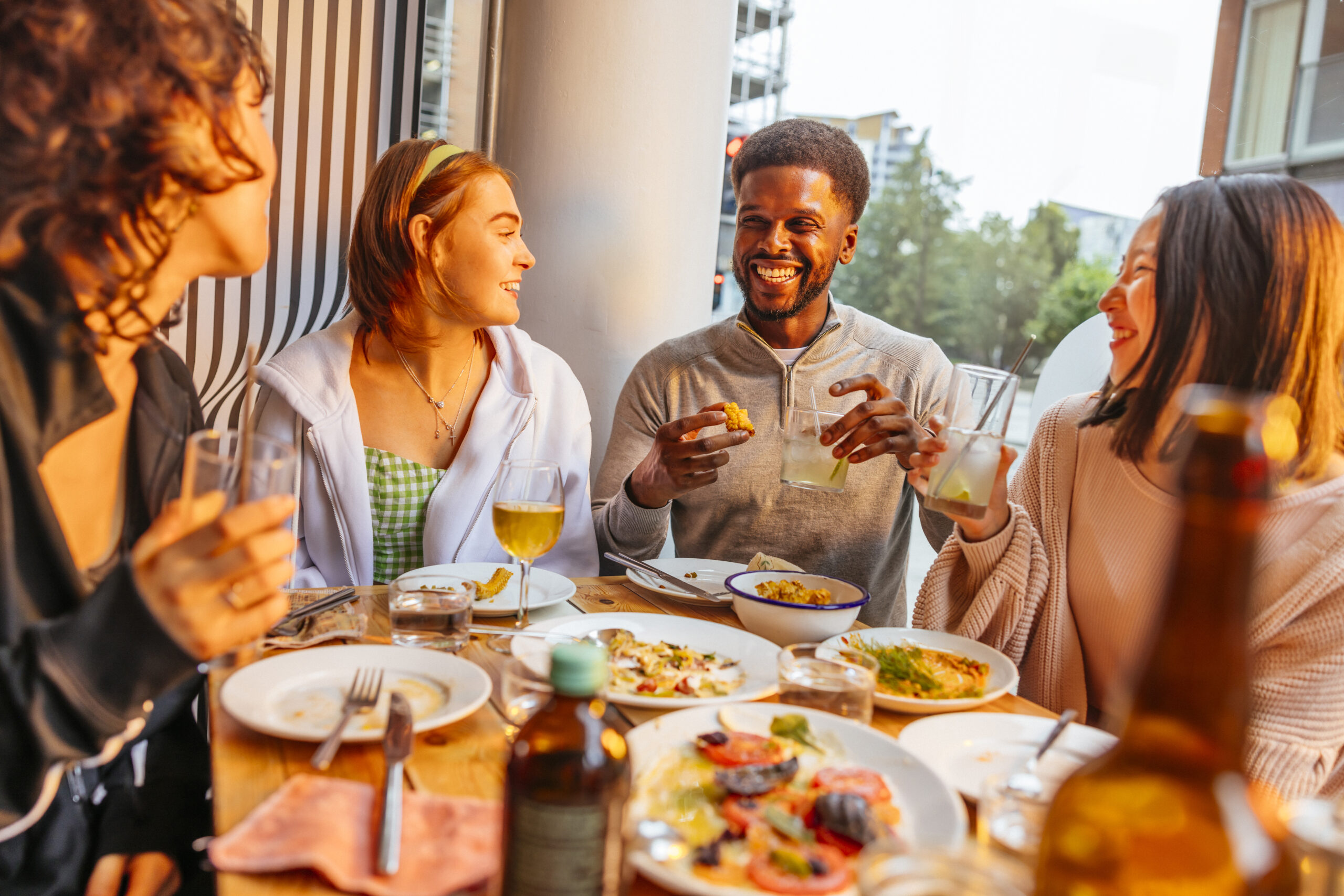 Group of friends enjoying a meal at Eat Your Greens restaurant.