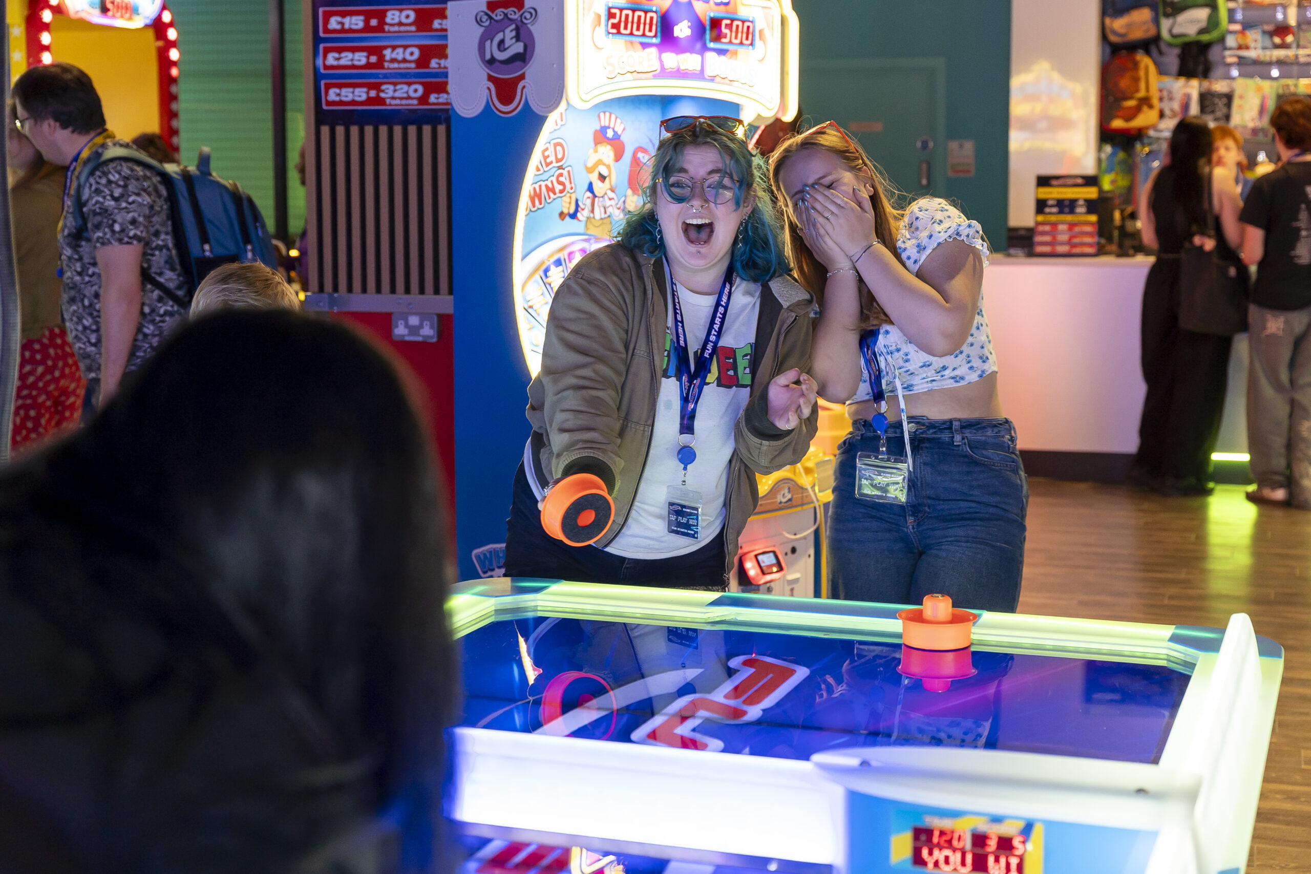 people playing arcade games