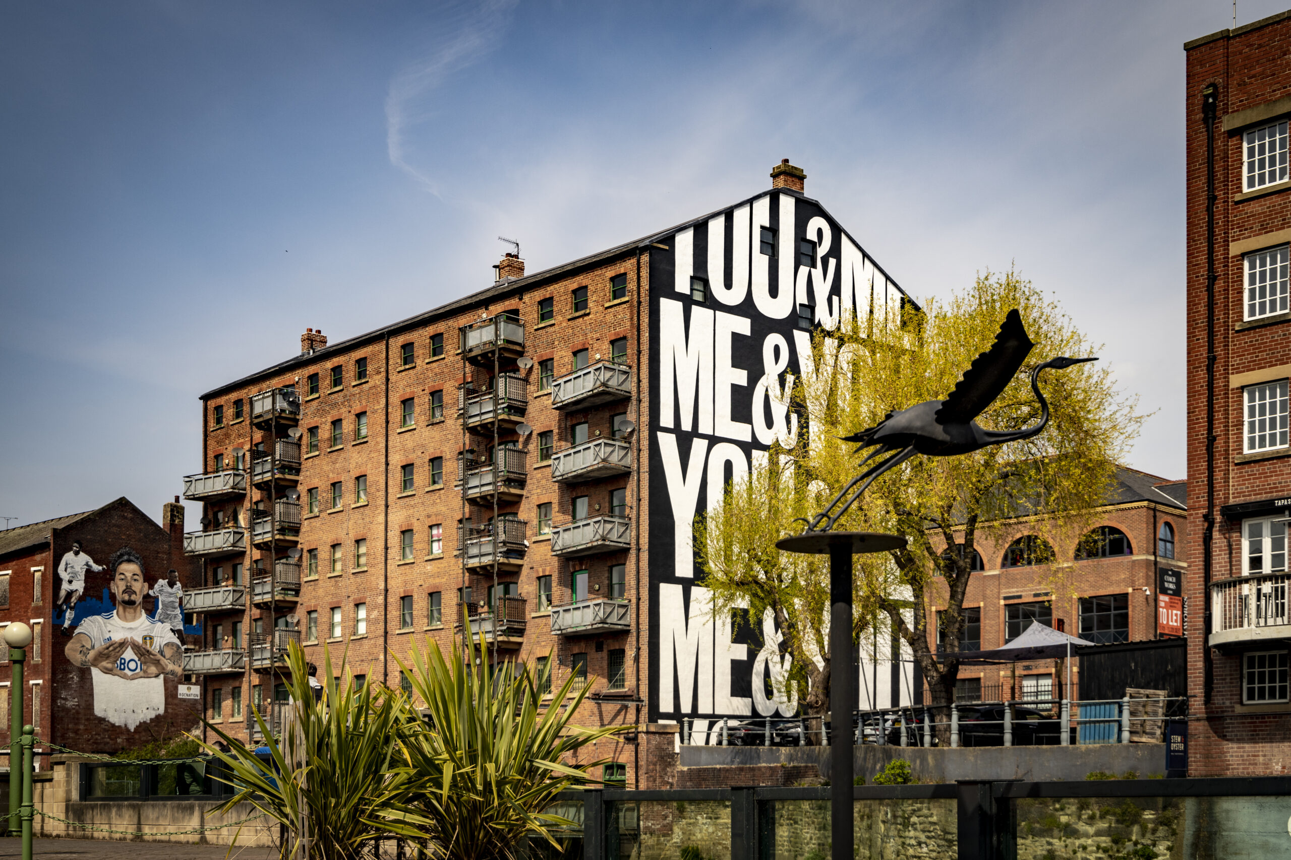 View of the city waterfront with view of trees and street art