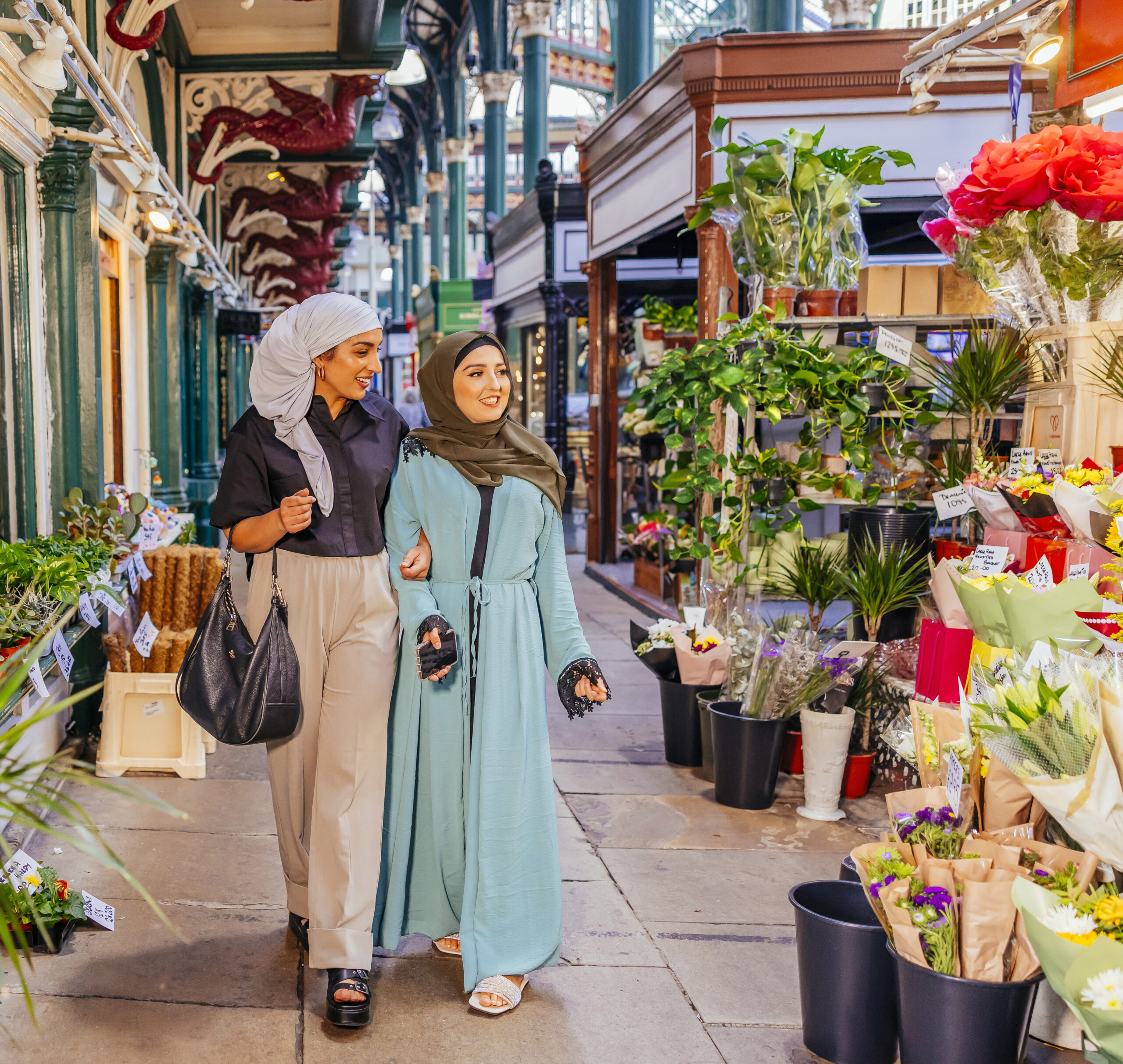 Two women browsing the flower stall at Kirkgate Market