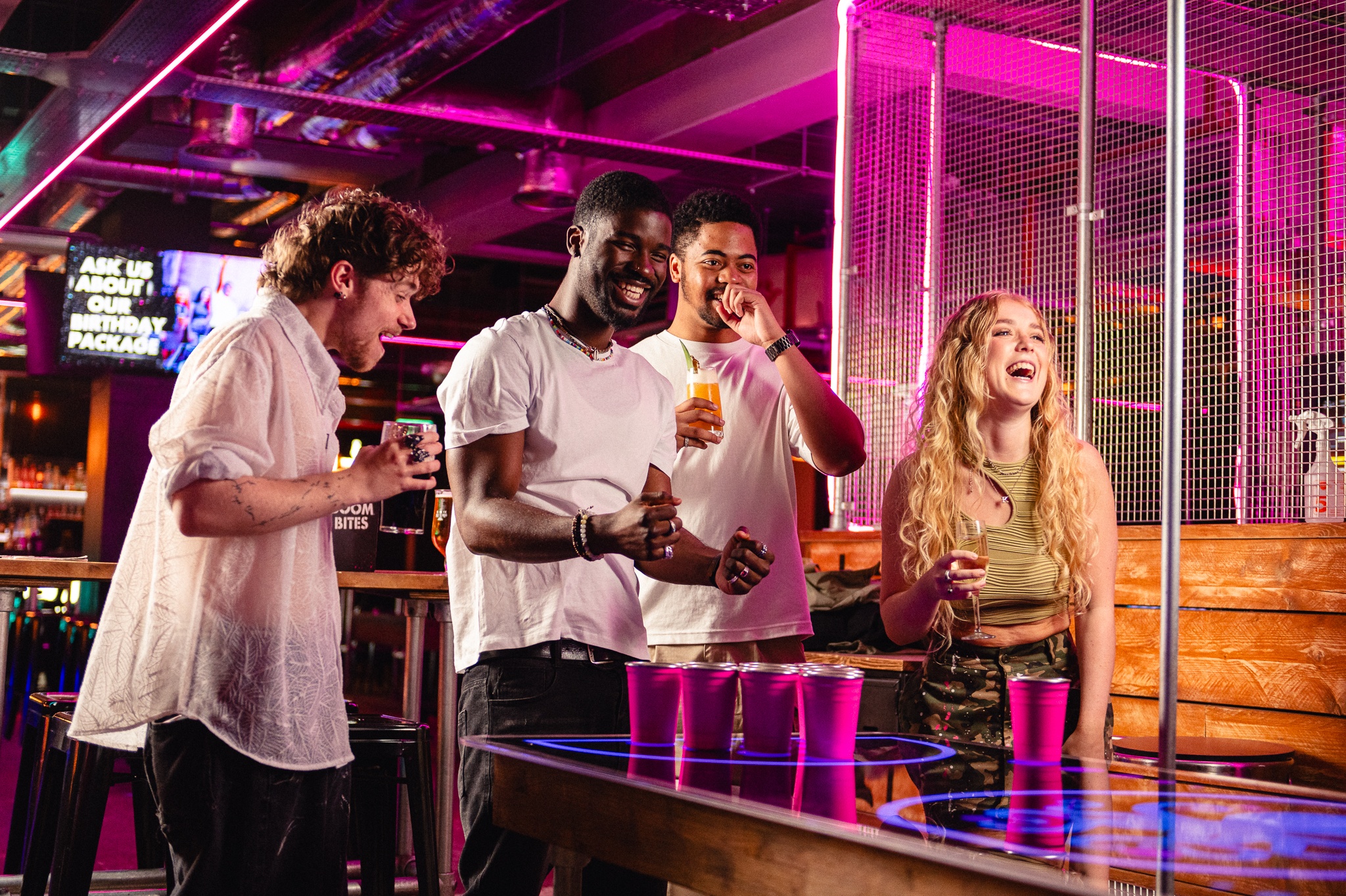 A group of friends laughing together at Boom Battle Bar