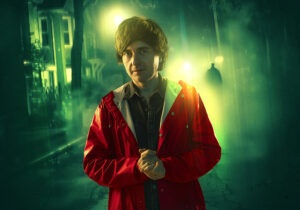 person in a raincoat with a gloomy background