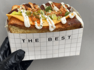 someone holding a brioche sandwich