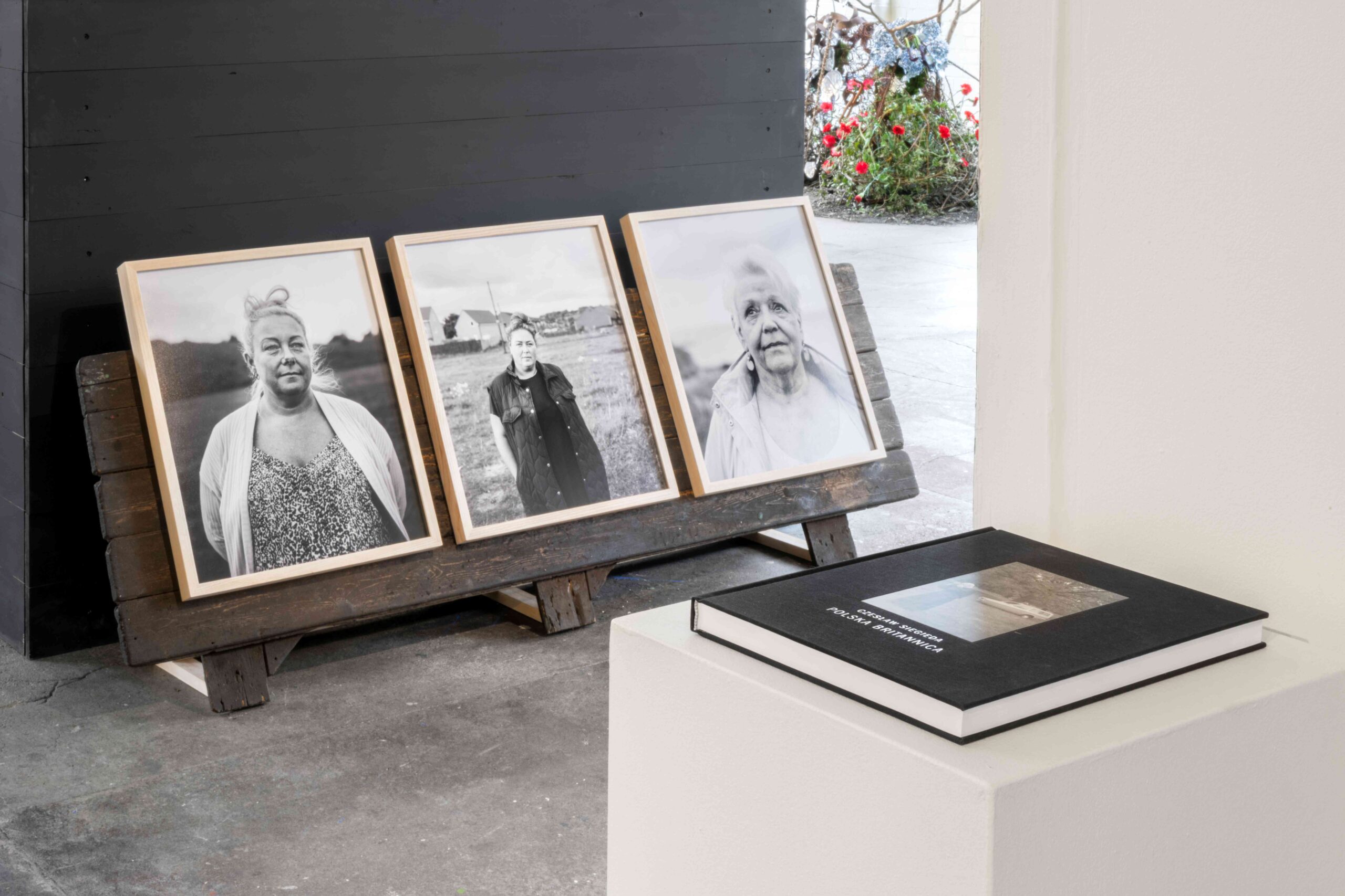 3 photographs displayed with a book in front