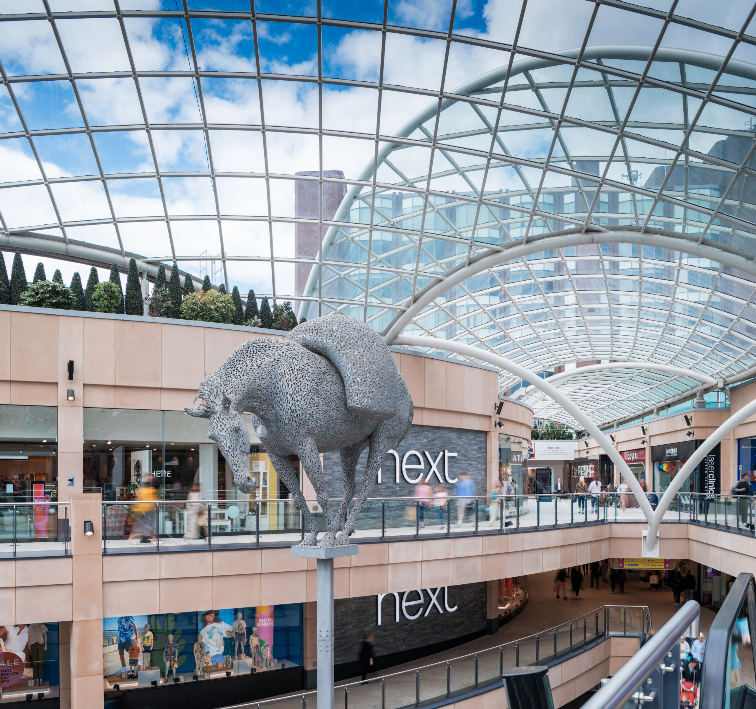 panoramic view of the Trinity shopping centre glass roof with a statue of a packhorse