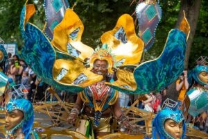 a person in a large flower costume in bright colours dancing