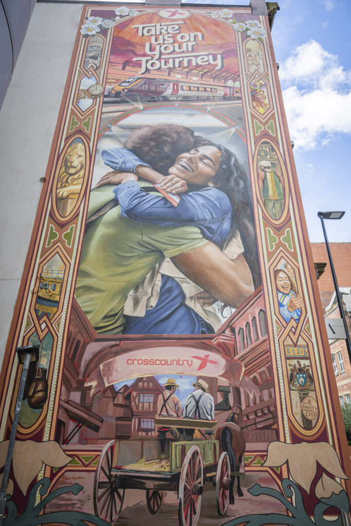 a large mural on the side of a building depicting a couple hugging and leeds icons around it like the water taxi and a wagon