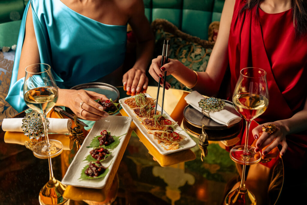 two people sharing plates of food