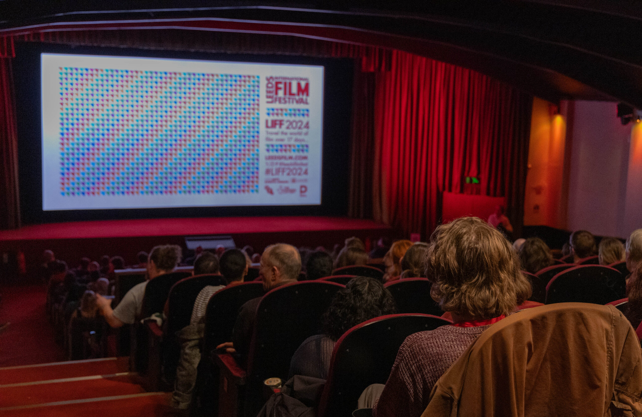 a movie theatre with people sat down
