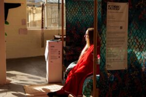 a woman sitting on a chair in a brightly lit room