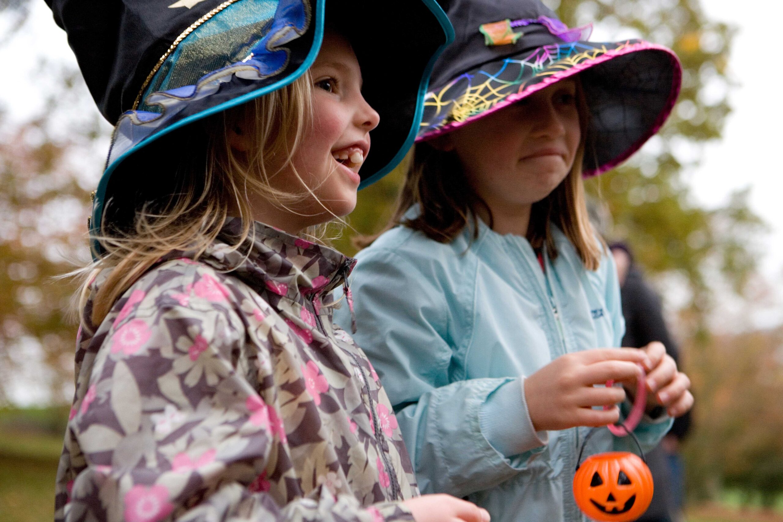 two children with witches hats in an outdoor setting