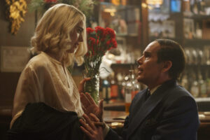 a still from the movie Blue Moon with a male and female actor sat at a bar