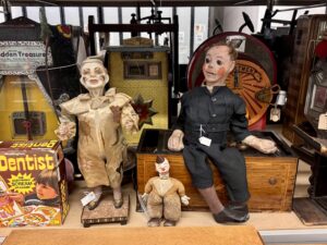 several old fashioned clown dolls in a storage facility