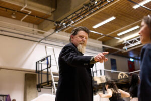 an actor practising in a rehearsal space facing the camera