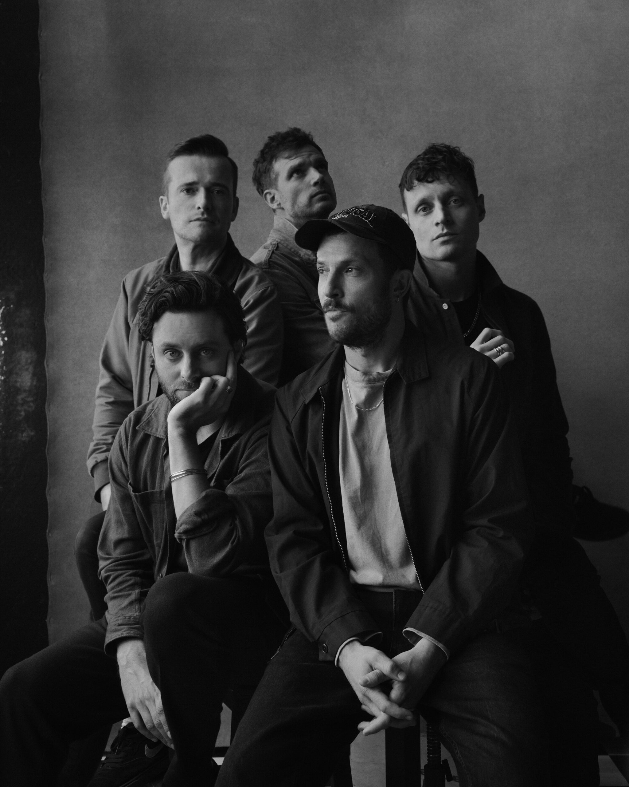 a black and white photo of five guys