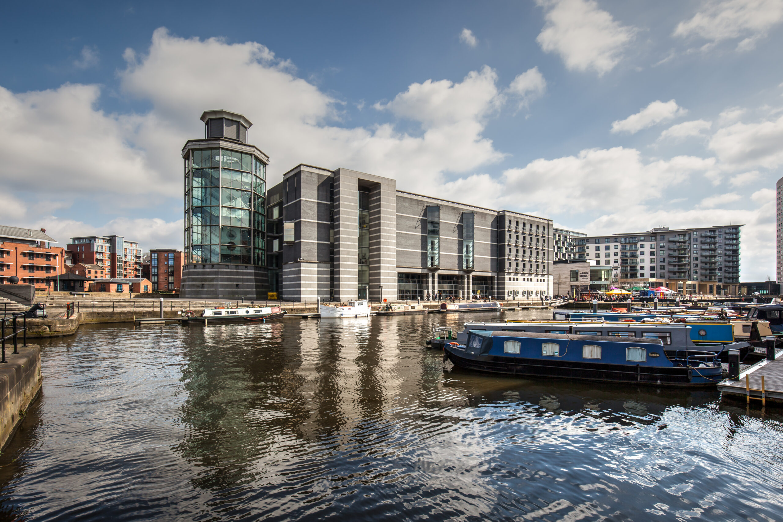 Exterior view of Royal Armouries Musuem at Leeds Dock, with water in the forefront.
