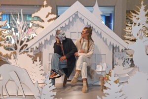 two people with one in makeup to look like a snow leopard, and another in gold and yellow as a deer