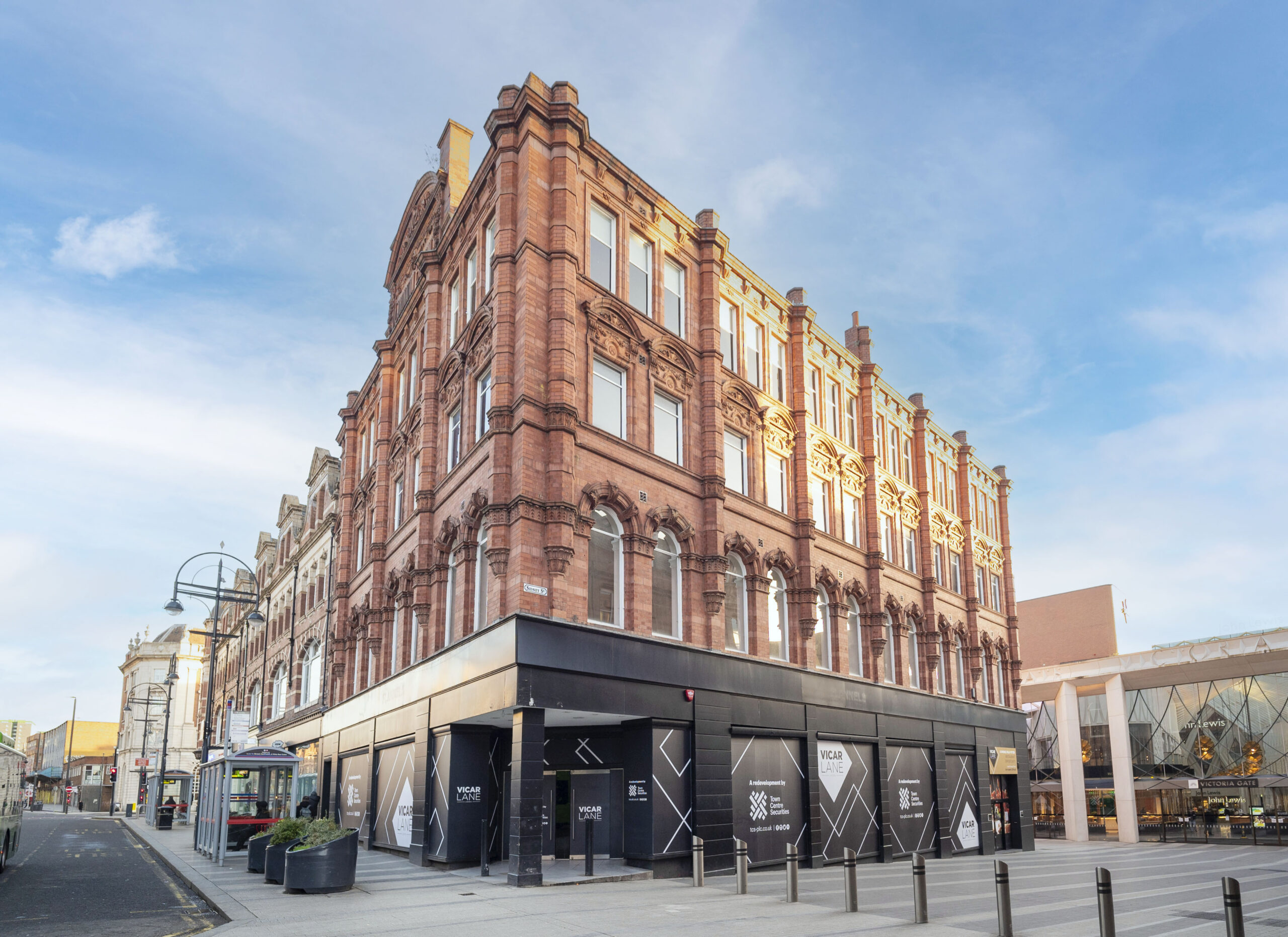 a large brick building with a blue sky