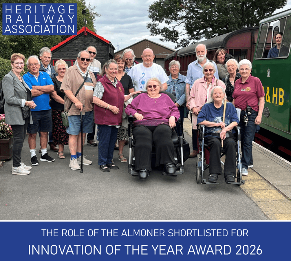 a large group of people posing for a photograph on a train platform