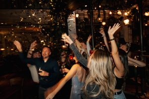 a group of people celebrating with confetti and champagne