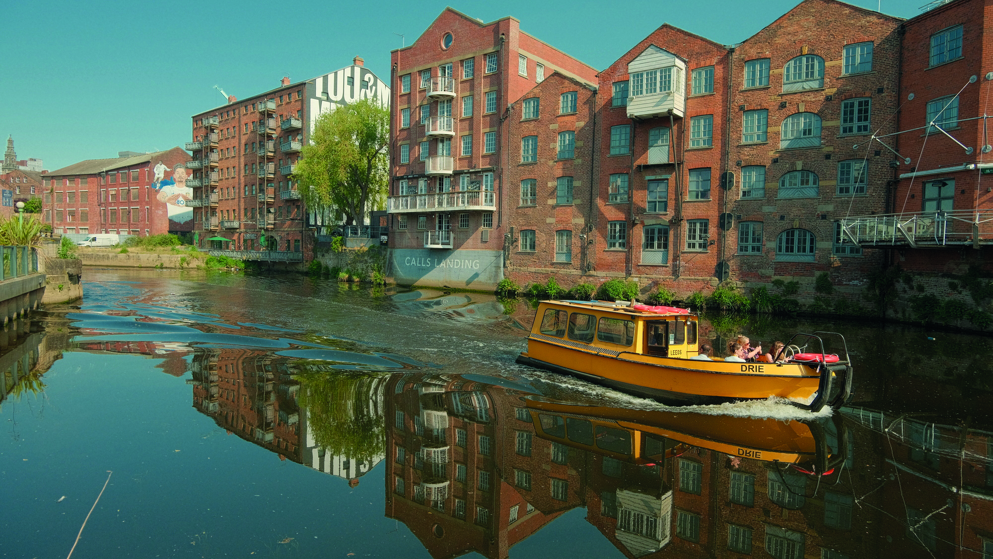View of Leeds Water Taxi on bright blue water.