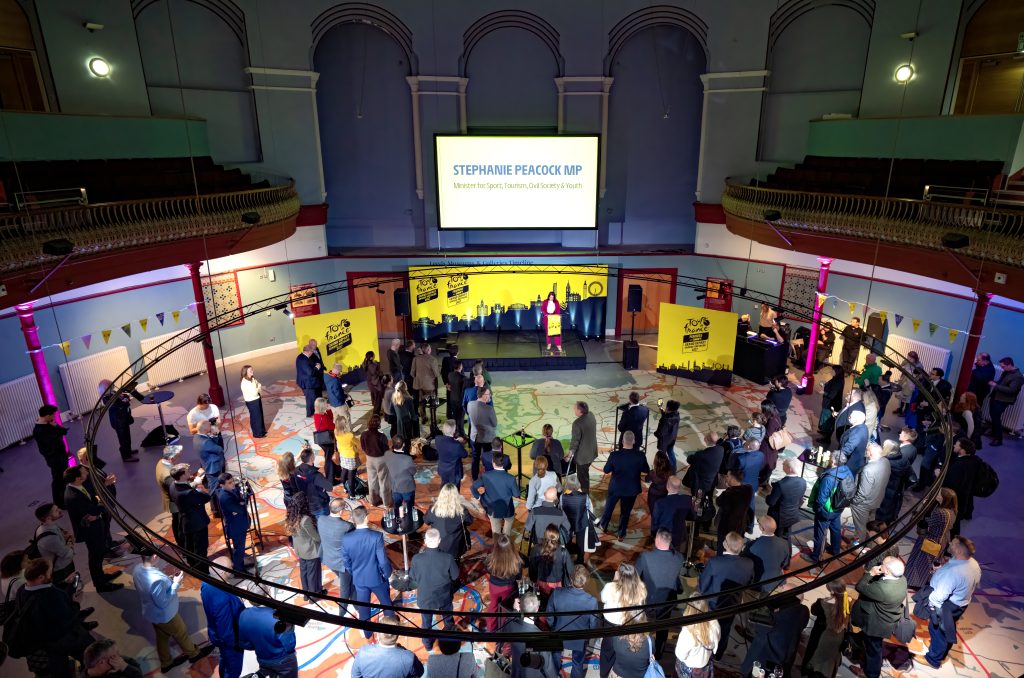 a large crowd of people gathered in a hall