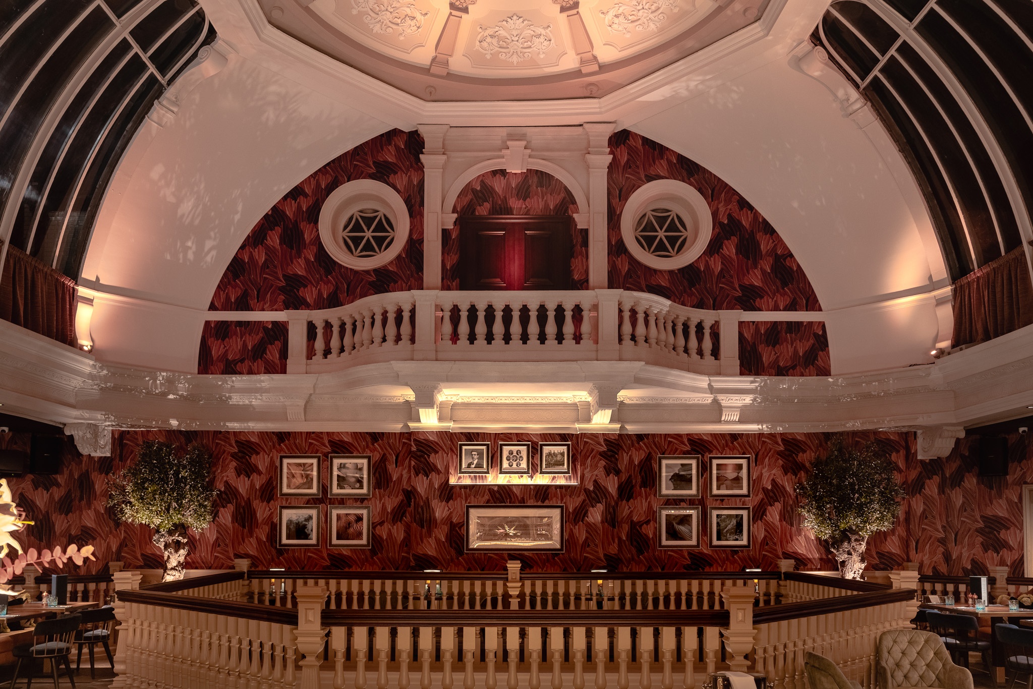 interior of a building, with a balcony, ornate decorations and a round ceiling